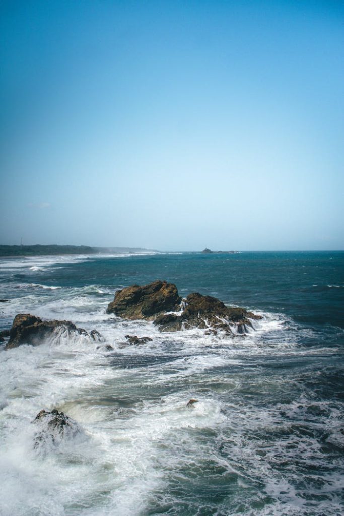 Dramatic seascape with rocky coastline and waves, Tasikmalaya, Indonesia.
